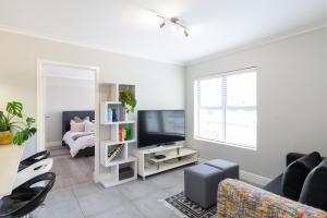 a living room with a tv and a couch at Paragon Devils Peak 3 Bed 2 Bath in Cape Town
