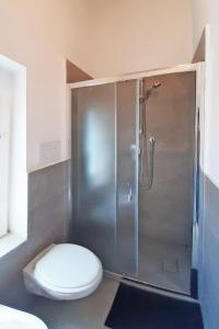 a bathroom with a toilet and a shower stall at Casa Brezza marina in Marina di Campo