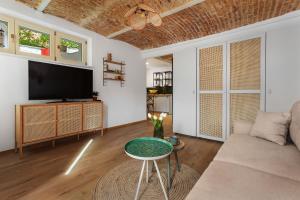 a living room with a couch and a tv at Roua Ludica Apartments in Braşov