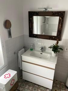 a bathroom with a white sink and a mirror at Casa Fulanita in Cabezuela