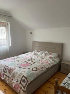 a bedroom with a bed with a quilt on it at Mariner House in Plav