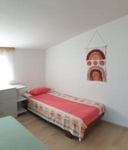a white bedroom with a bed and a dresser at Vila Maria in Vir