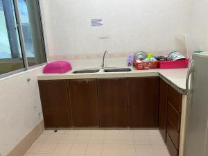 a kitchen with a sink and a refrigerator at D'Puncak Arabella Muslim Homestay in Cameron Highlands +39 photos
