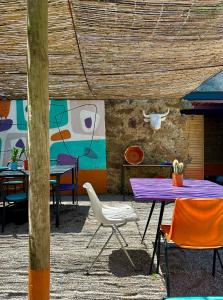 une table et des chaises violettes devant un mur dans l'établissement Convento Senhora da Vitória, à Castelo de Vide