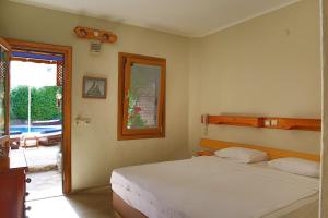 A bed or beds in a room at UzHan Beach Hotel