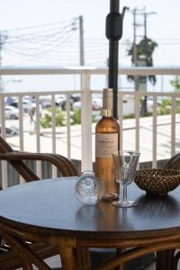 a bottle of wine sitting on a table with a glass at KLEIO in Nea Moudania