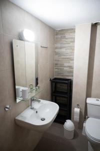 a bathroom with a sink and a toilet at KLEIO in Nea Moudania