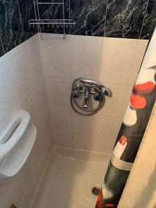 a bathroom with a shower with a sink and a tub at KONTI VILLA in Kondáraina