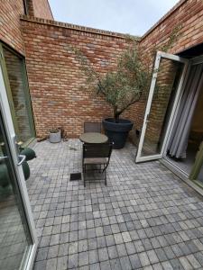 a patio with a table and chairs and a brick wall at Amazing 5 Stars Home in London