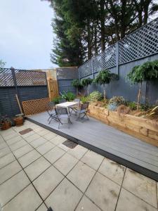 a patio with a table and chairs and a fence at Amazing 5 Stars Home in London