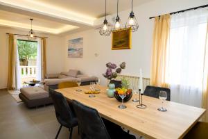 a large wooden table in a living room at Insula Apartment with Private Pool in Pučišća