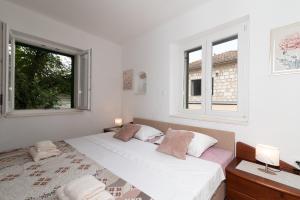 Postel nebo postele na pokoji v ubytování Filomena Rooms