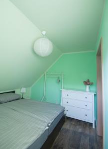 a bedroom with a bed and a white dresser at Ferienhaus Lilly in Hain