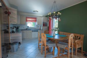 a kitchen and dining room with a wooden table and chairs at Ferienhaus Lilly in Hain