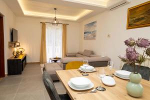 a dining room and living room with a table and chairs at Insula Apartment with Private Pool in Pučišća +20 photos