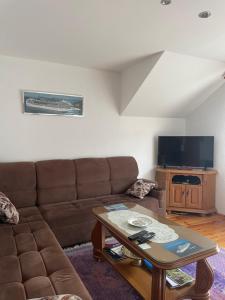 a living room with a couch and a table at Mariner House in Plav