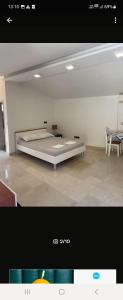 a bedroom with a large bed in a room at H&D Apartment in Sumartin