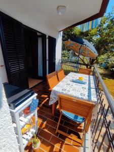 a patio with a table and chairs and an umbrella at Apartments Novigrad in Novigrad Istria