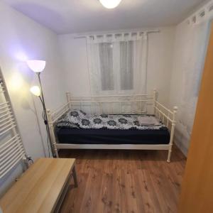 a bed in a room with a window and a table at Apartments Garden in Koper