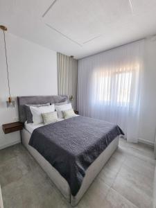 a bedroom with a large bed and a window at Adria Mare in Crikvenica