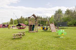 a park with a playground with a slide and a bench at Saare Paadiküla 