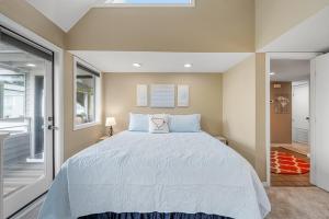 a bedroom with a large bed with blue pillows at Arcadian Dunes 312 in Myrtle Beach
