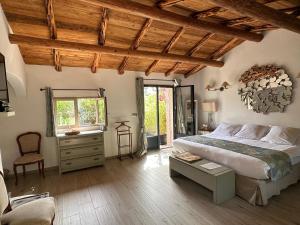 a bedroom with a bed and a chair and a window at Hôtel Ambassador Palombaggia in Porto-Vecchio +37 photos