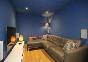 a living room with a couch and a blue wall at Kingswood in Edinburgh