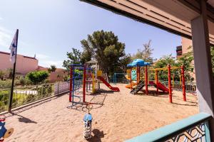 a playground in the sand with slides and swings at Rose Aqua Park Hotel in Marrakech