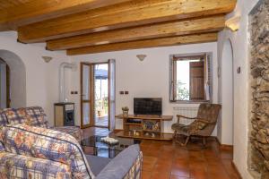 - un salon avec un canapé et une télévision dans l'établissement Cottage Casale relax e tranquillità, à Gioiosa Marea