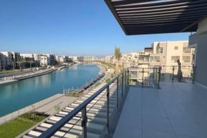 a view of a river from the balcony of a building at MKD Marina Residence in El Alamein