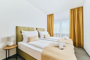 two beds in a room with a window at Apartments San Maris 2 in Umag