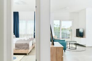 a bedroom with a bed and a couch and a tv at Apartments San Maris 2 in Umag