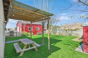 a picnic table in a yard with a red barn at Beautiful Oasis with rv or boat parking in Las Vegas