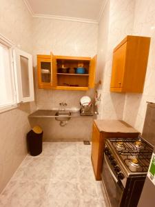 a small kitchen with a sink and a stove at Marina Hills Residence in El Alamein