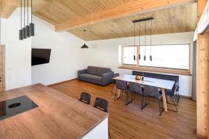 a kitchen and living room with a table and chairs at Ferienhaus Urlpold in Schladming