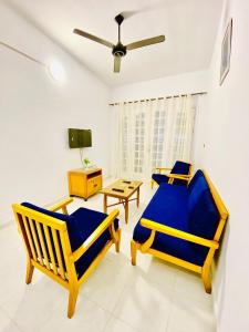 a living room with two chairs and a table at Marina Hills Residence in El Alamein