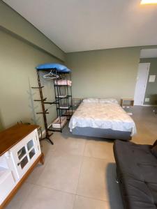 a bedroom with a bed and a ladder in it at Sem Taxas! Studio Central, Moderno e C/ Garagem in Pelotas
