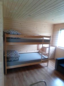 a room with two bunk beds in a cabin at Domki Bieszczady Całoroczne in Olszanica