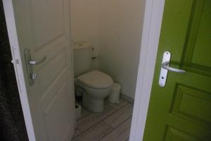 a small bathroom with a toilet and a door at appartement autonome in Prémilhat