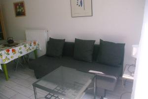 a living room with a couch and a table at appartement autonome in Prémilhat