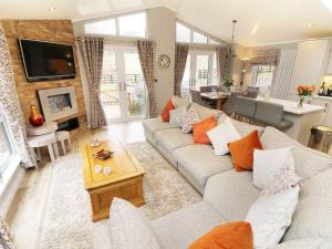 a living room with a couch and a table at 8 Waterside Wood in Windermere