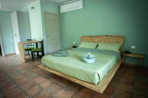 a bedroom with a bed with towels on it at Il Bosco Incantato in Borgo San Dalmazzo