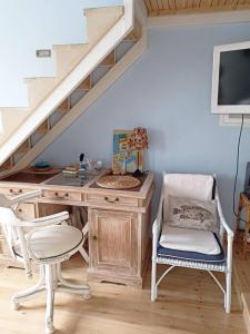 a desk and chair in a room with a staircase at Blue & White Cycladic house - 100m from the beach in Megas Gialos - Nites