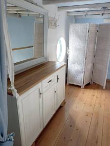 a room with a large mirror and a wooden floor at Blue & White Cycladic house - 100m from the beach in Megas Gialos - Nites +25 photos