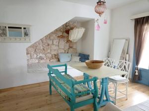 a dining room with a table and chairs at Blue & White Cycladic house - 100m from the beach in Megas Gialos - Nites