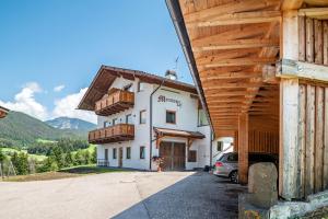 a building with a car parked in front of it at Morodeserhof Apt Bühlen 2 in Castelrotto