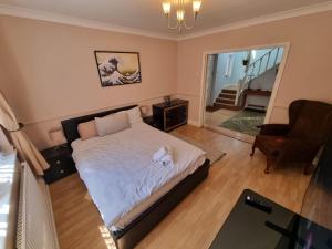 ein Schlafzimmer mit einem Bett, auf dem ein Stofftier liegt in der Unterkunft 6 Bedroom Huge Holiday Home with parking in Luton