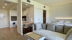 a living room with a couch and a bed at Empordà Golf 4 1-3 in Gualta