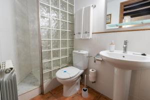 uma casa de banho branca com um WC e um lavatório em Apartamento Can Lo 2 em Rupit